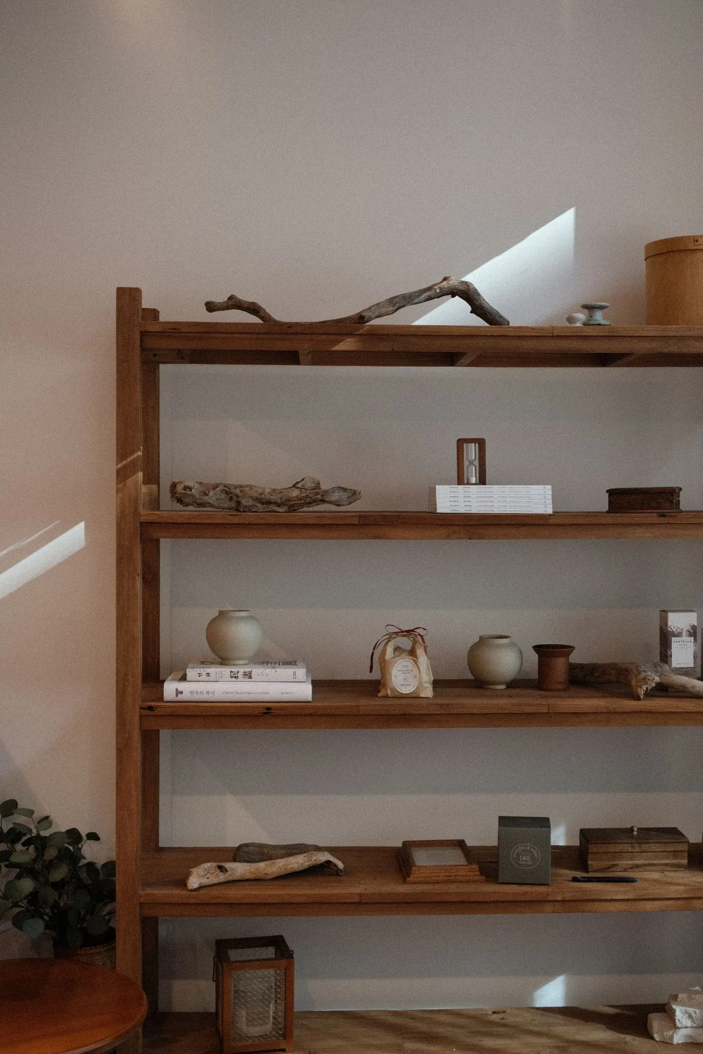 Open wooden shelving with ceramics and small objects